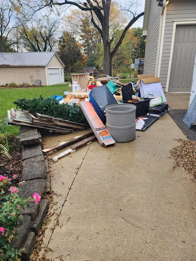 Dumpster being loaded with debris for 12 Yard Dumpster Rental in Marion